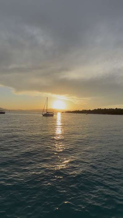Sailboat at sunset near the islands